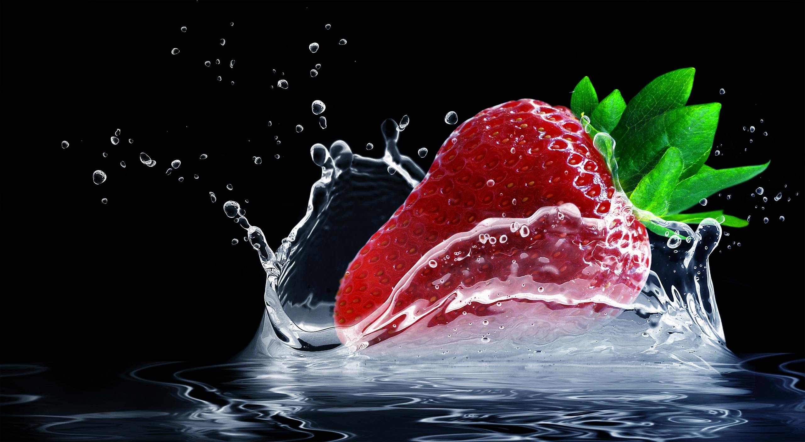 Dynamic shot of a strawberry splashing into water with vivid colors against a black background.