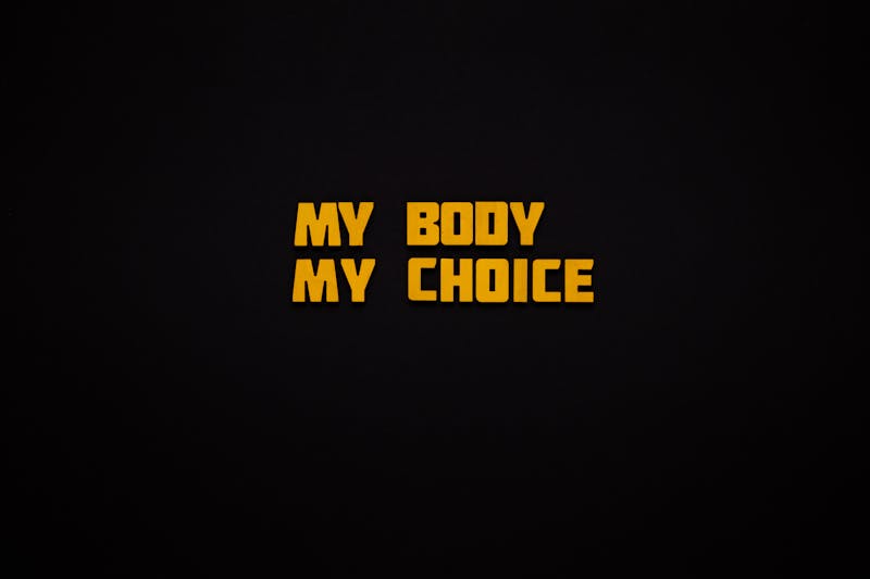 Bold 'My Body My Choice' phrase on a minimalist black background.
